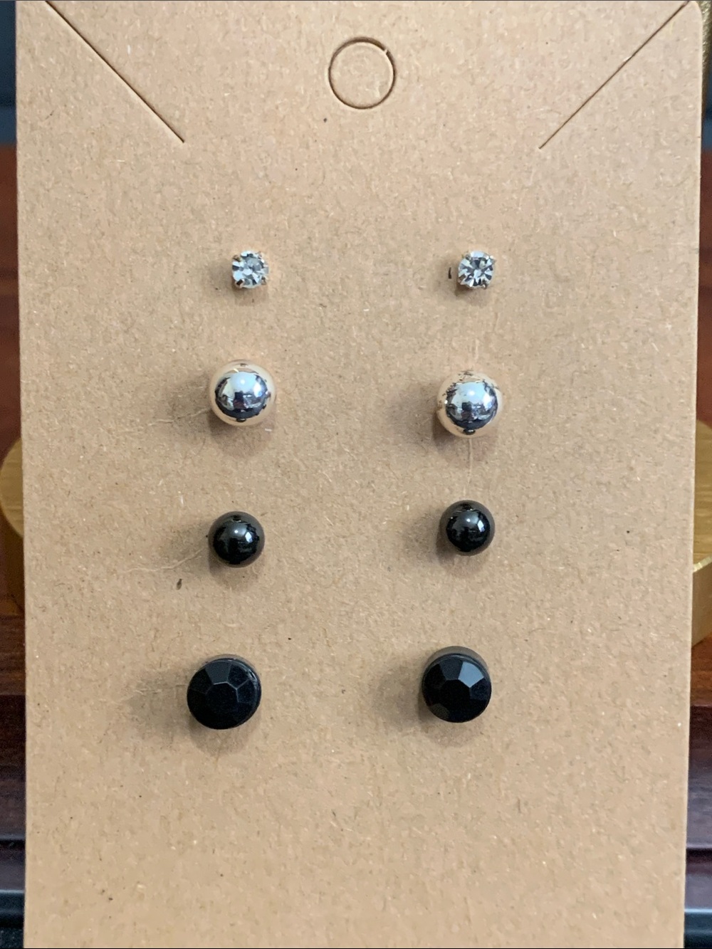 4 pairs of silver tone and black stud earrings